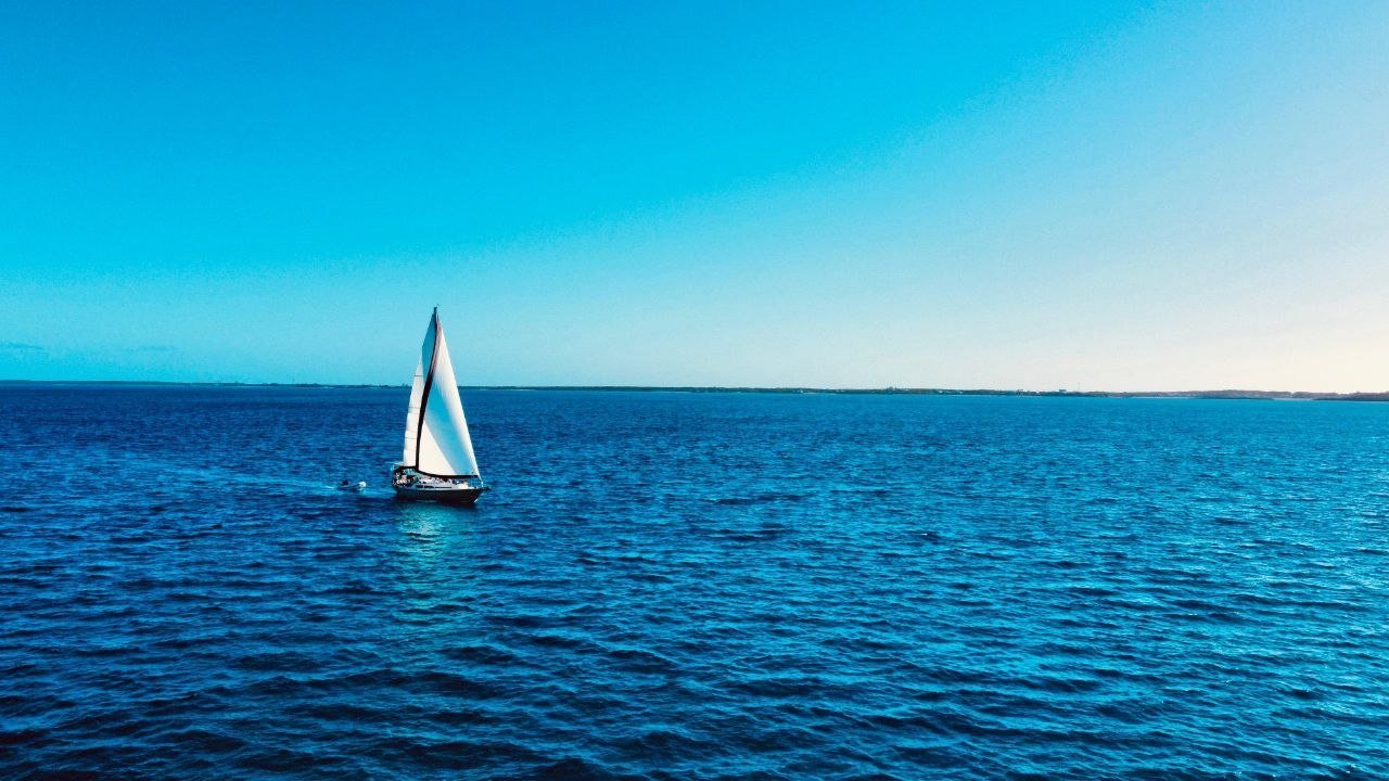 Aerial of sailboat on open sea