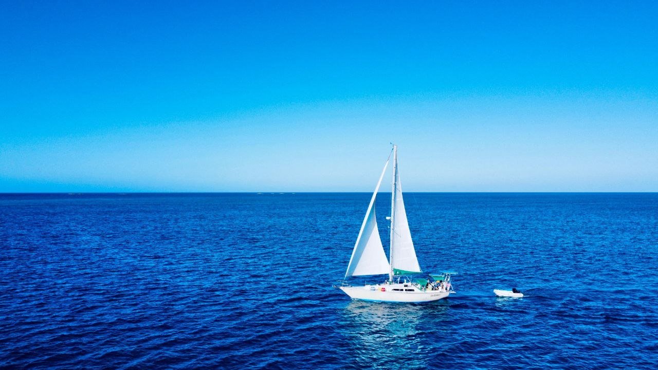 Sea Monkey under sail with dinghy
